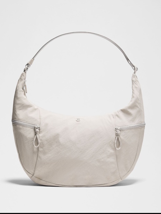 lululemon athletica Handbags - Lululemon Large Slouchy Sling Bag 13L light ivory with silver-NWT